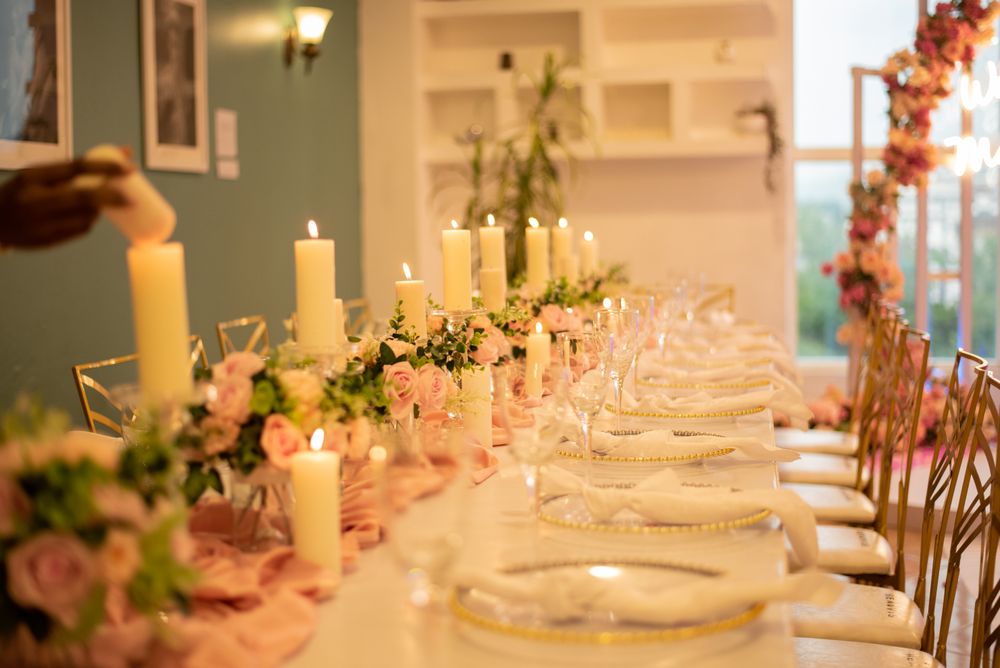 A candlelit banquet table dressed with flowers and glassware at a reception in Lagos